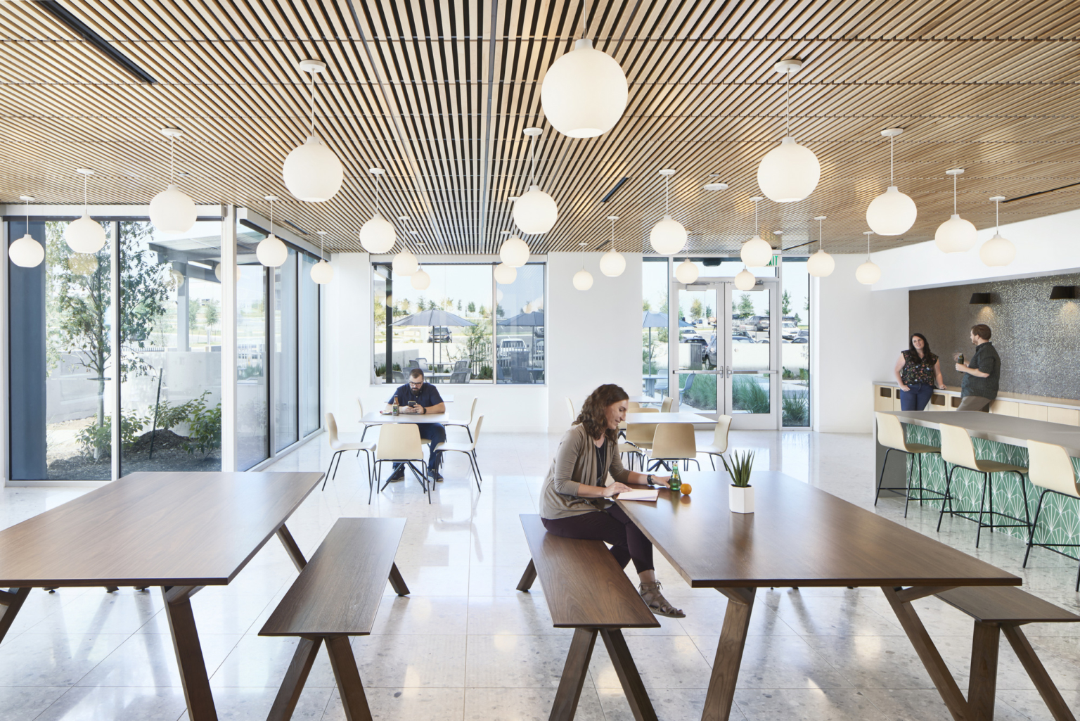 Light-filled 3M Austin collaborative space with installed tables and seating
