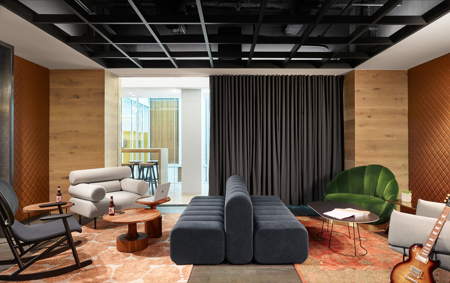 Dropbox Austin lounge with upholstered seating and wood tables