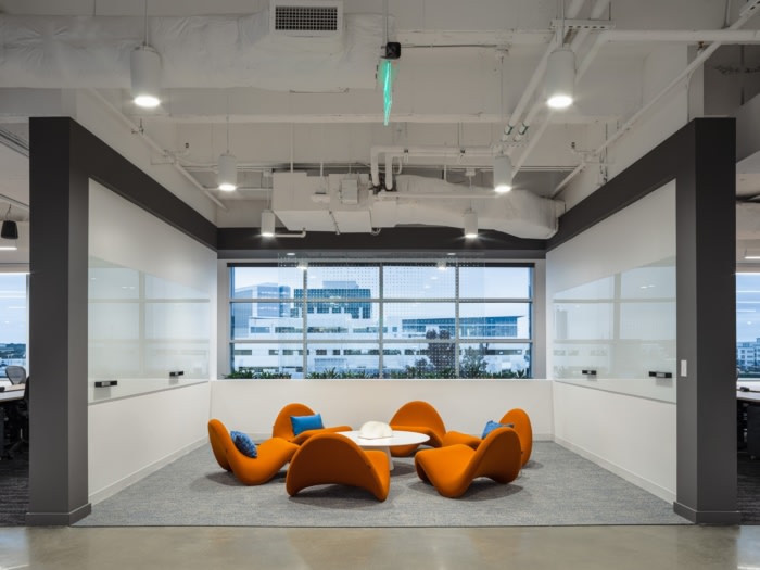 Indeed Austin collaboration area with orange lounge chairs