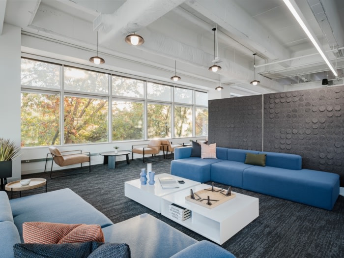 Indeed Austin lounge with blue sofas and seating beside large windows