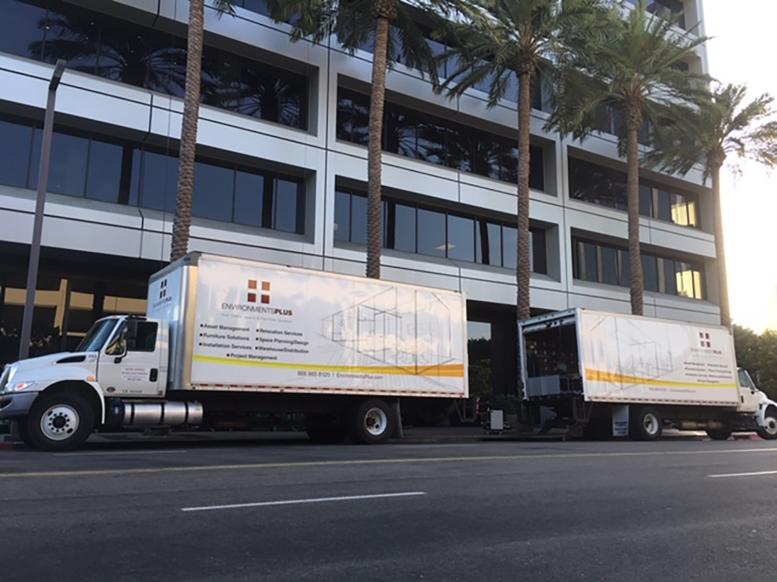 Environments Plus delivery trucks outside a commercial building